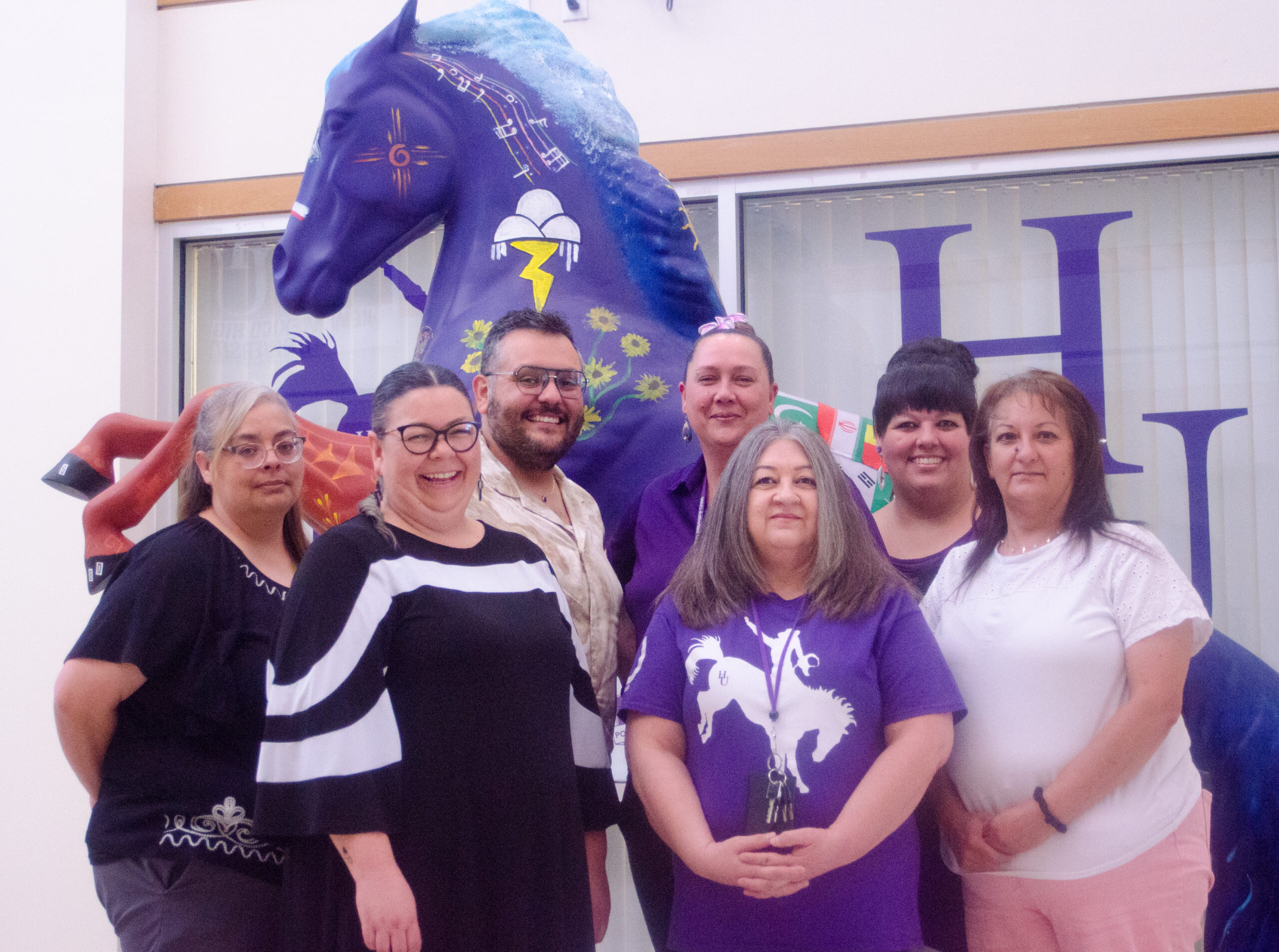 Back Row: Angel Benavidez Graduate Records and Center Coordinator (Graduate Liaison to the Office of the Registrar) , Michael Montoya, Assistant Registrar, Cheryl Trujillo, Transfer Analyst & Systems Administrator, Andrea Crespin, Scheduling & Special Projects Coordinator Front Row: Dr. Henrietta Romero, University Registrar, Deborah Gonzales, Senior Administrative Assistant, Sara Duran, Student Transcript Specialist Posing in front of the NMHU Horse Statue in the Student Union Building