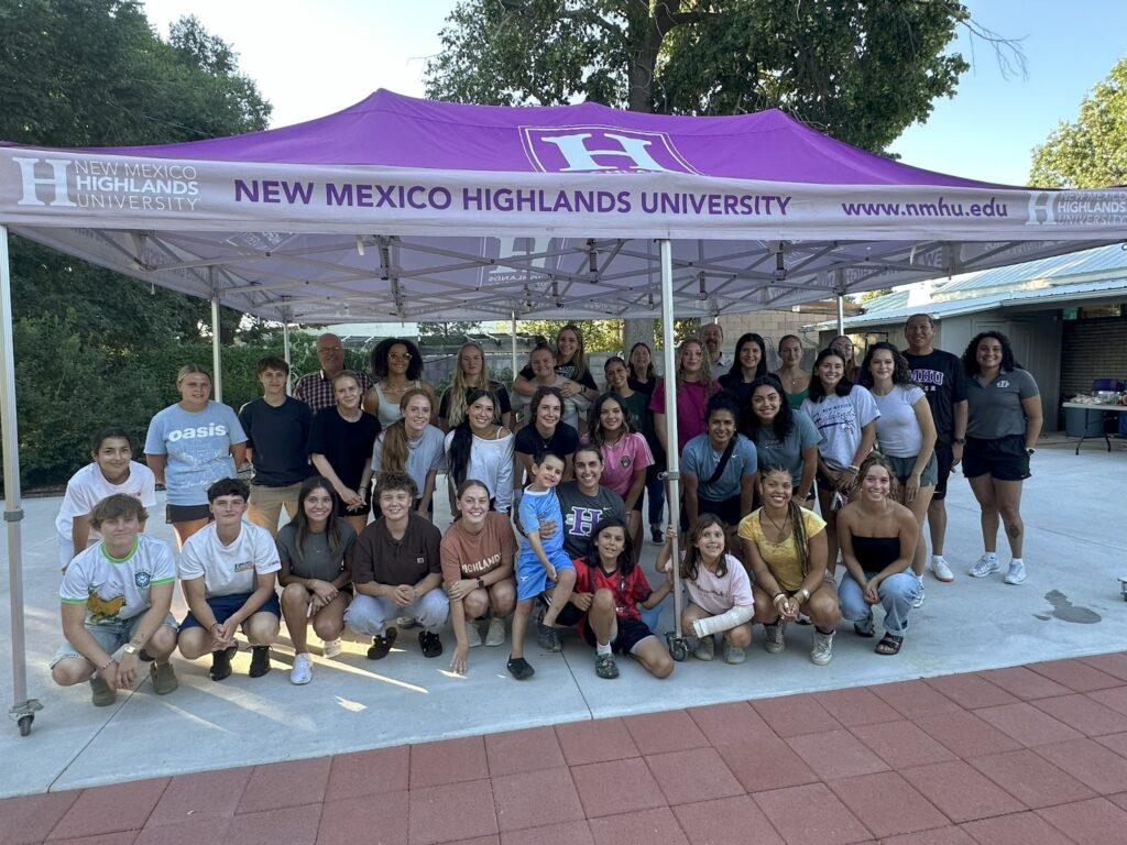 Picture of the NMHU soccer team meeting with President Woolf.