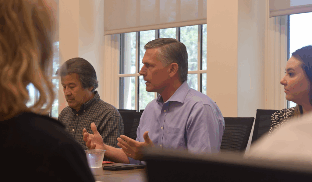 New Mexico Senator Martin Heinrich sitting at a table meeting with officials.