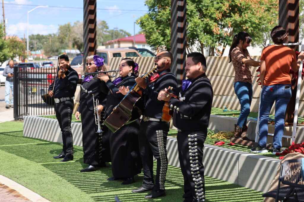 A mariachi band performing on an outdoor stage.