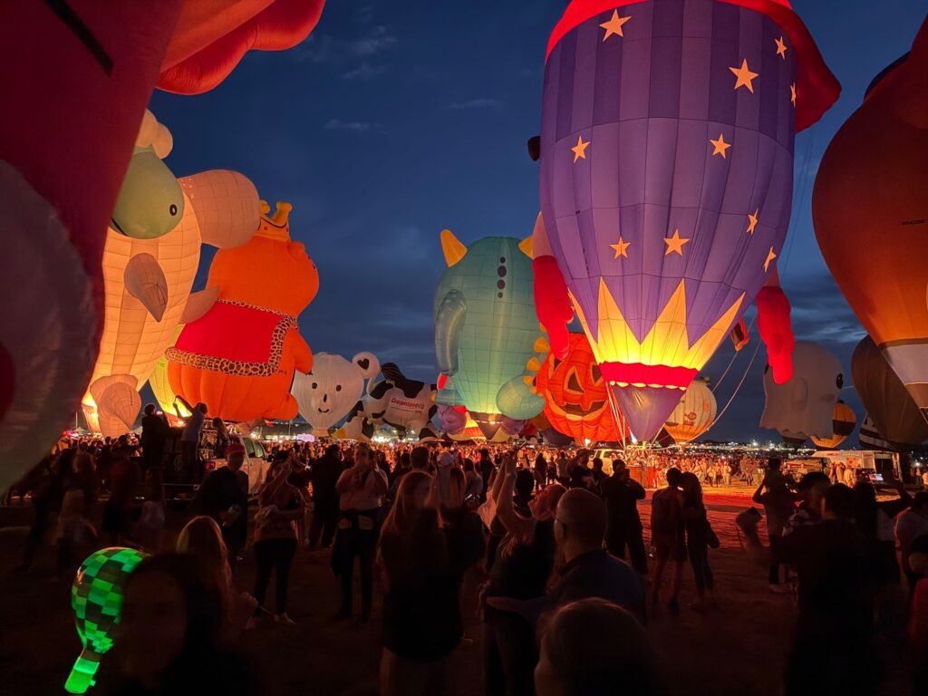 Image of hot air balloons lighting up at twilight.