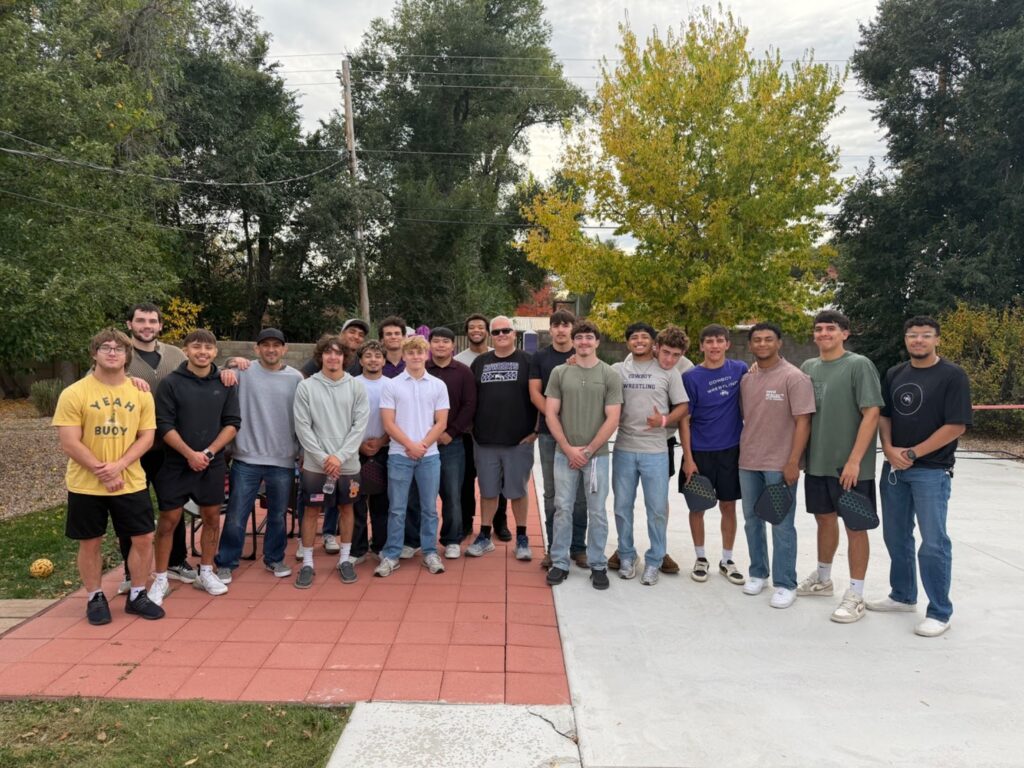 The NMHU wrestling team meeting with President Woolf.