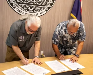 Representatives from NMHU and American Samoa signing the agreement.