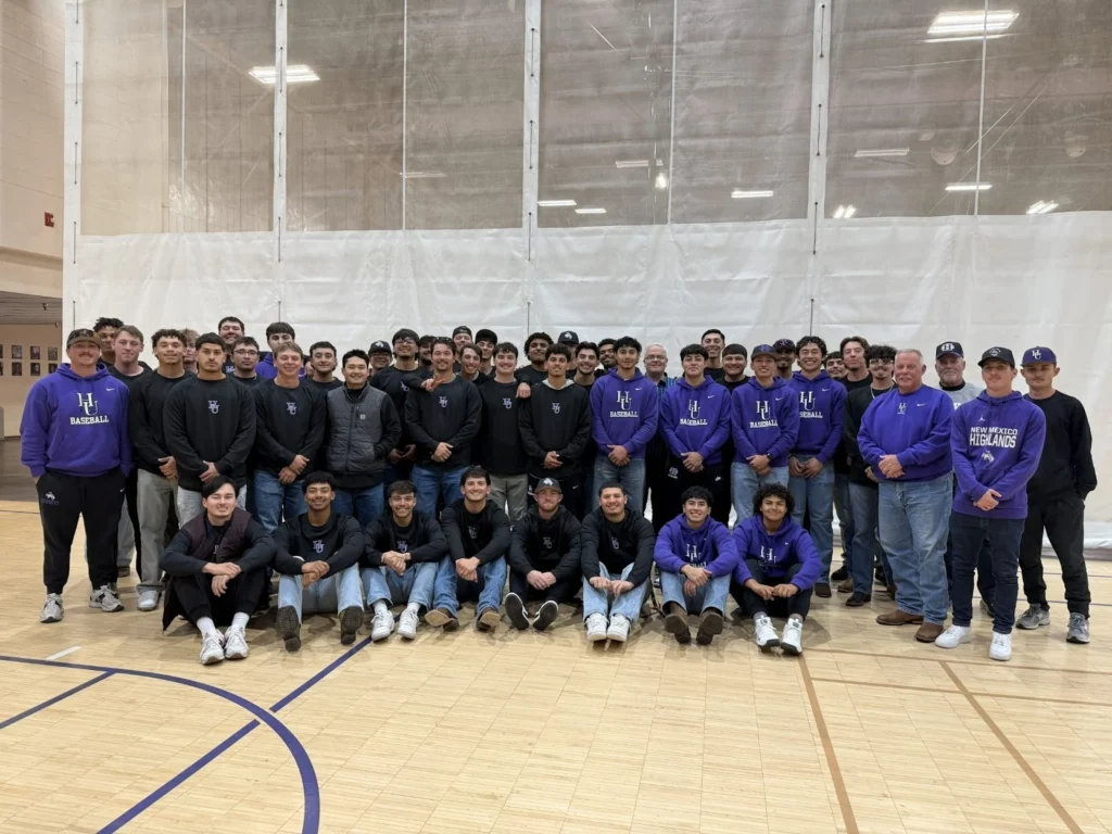 Image of President Woolf with the NMHU Baseball and Football teams