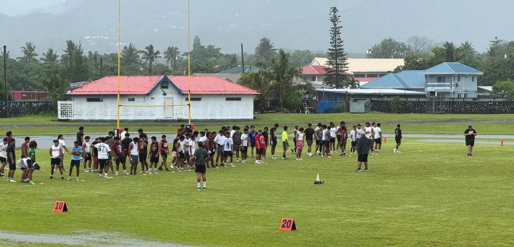 Student athletes on the field during football camp.