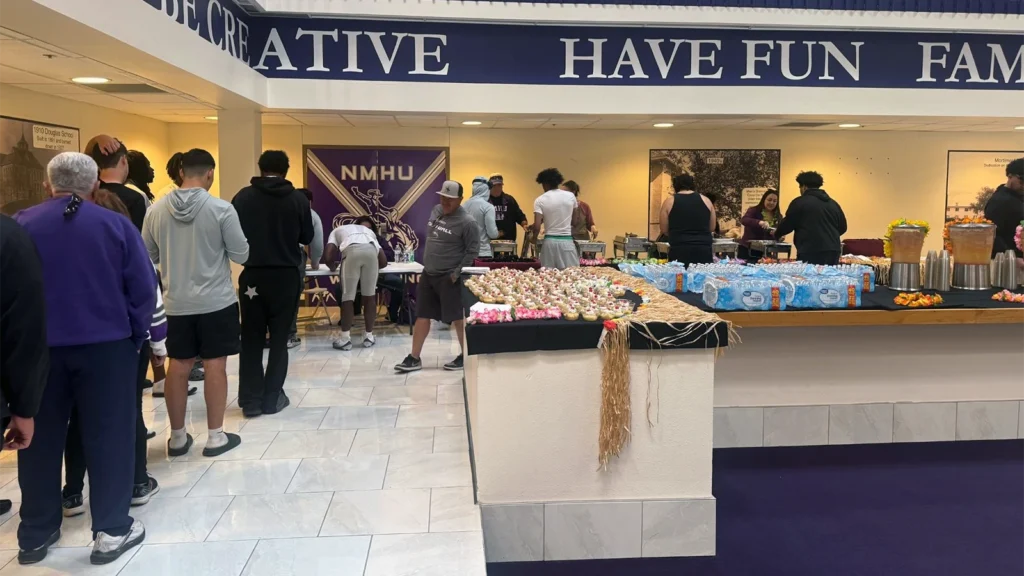 New Mexico Highlands students, athletes and community members are being served food at a buffet in the Wilson Center.