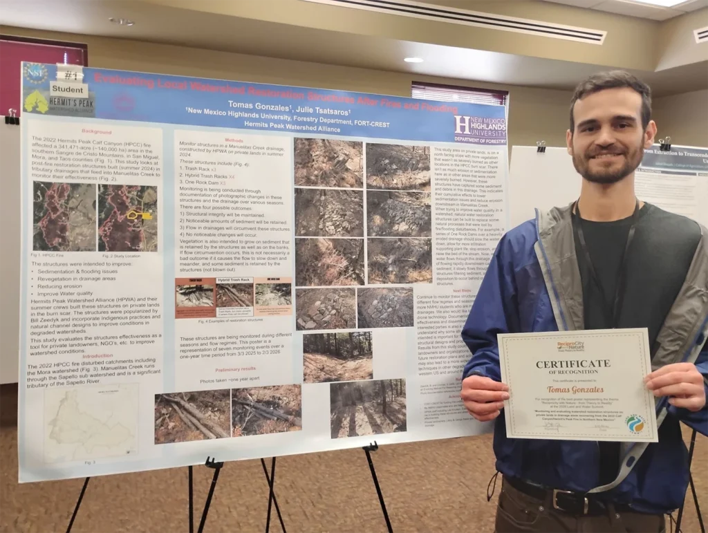 NMHU Forestry undergraduate student Tomas Gonzales stands with his presentation poster holding his award.