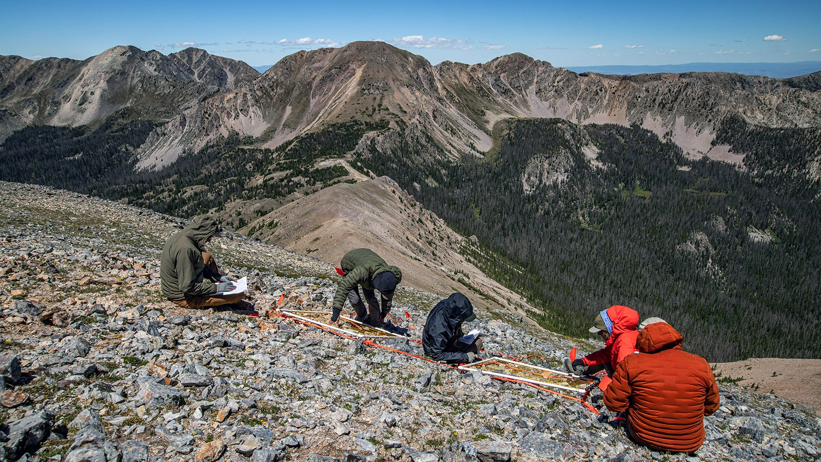 Researchers on a mountainside.